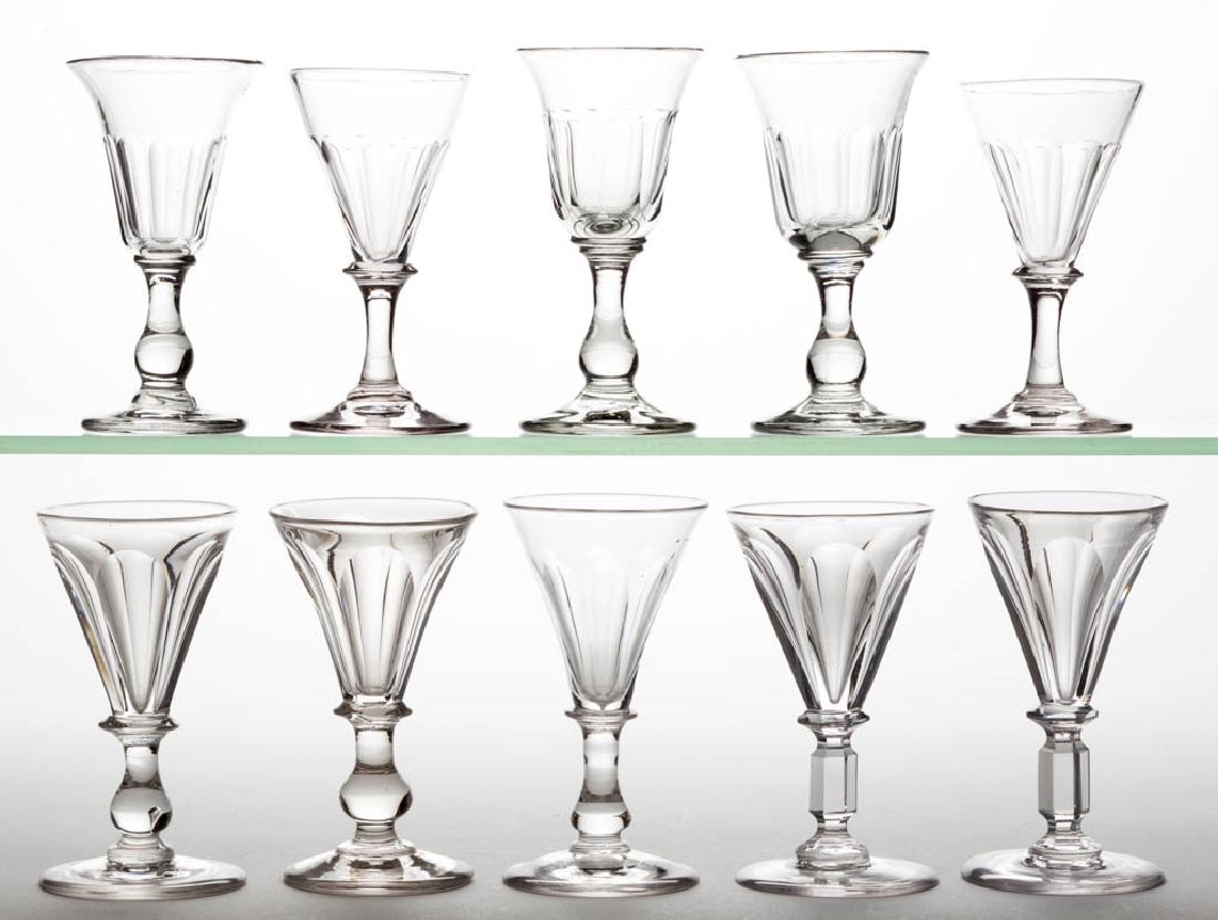 ASSORTED BLOWN AND CUT-FLUTED WINE GLASSES, LOT OF TEN: ASSORTED BLOWN AND CUT-FLUTED WINE GLASSES, LOT OF TEN, colorless lead glass, including four six-flute and three nine-flute examples, seven pieces with a polished pontil mark. Various makers. 19th cen