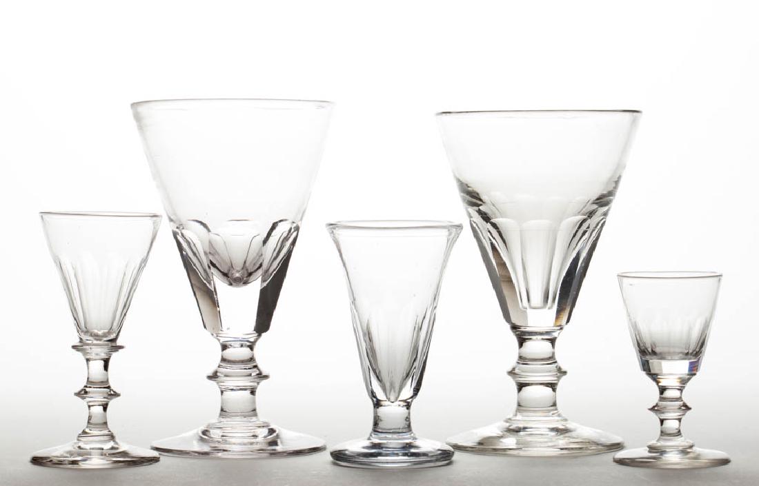 ASSORTED BLOWN AND CUT DRINKING VESSELS, LOT OF FIVE: ASSORTED BLOWN AND CUT DRINKING VESSELS, LOT OF FIVE, colorless, comprising two goblets, two wines, and a firing glass, each with a polished pontil mark. Various makers. 19th century. 3 1/4" to 6 1/4"