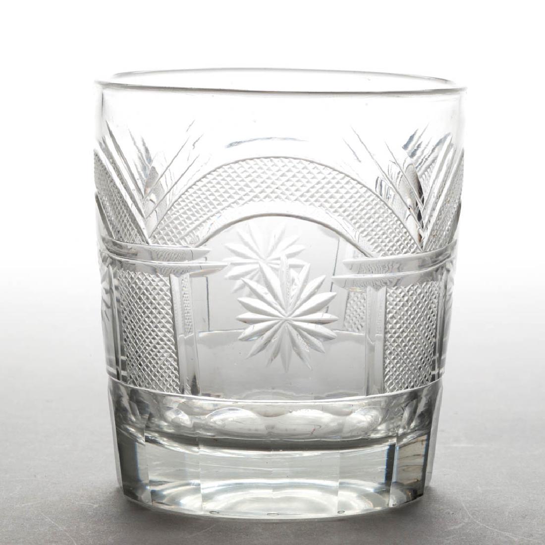 CUT MASONIC TUMBLER: CUT MASONIC TUMBLER, colorless lead glass, Masonic pattern with arches and stars, cut-panelled base, polished pontil mark. Pittsburgh. 1815-1835. 3 1/4" H. Undamaged. Literature: Parallels Innes - Pit