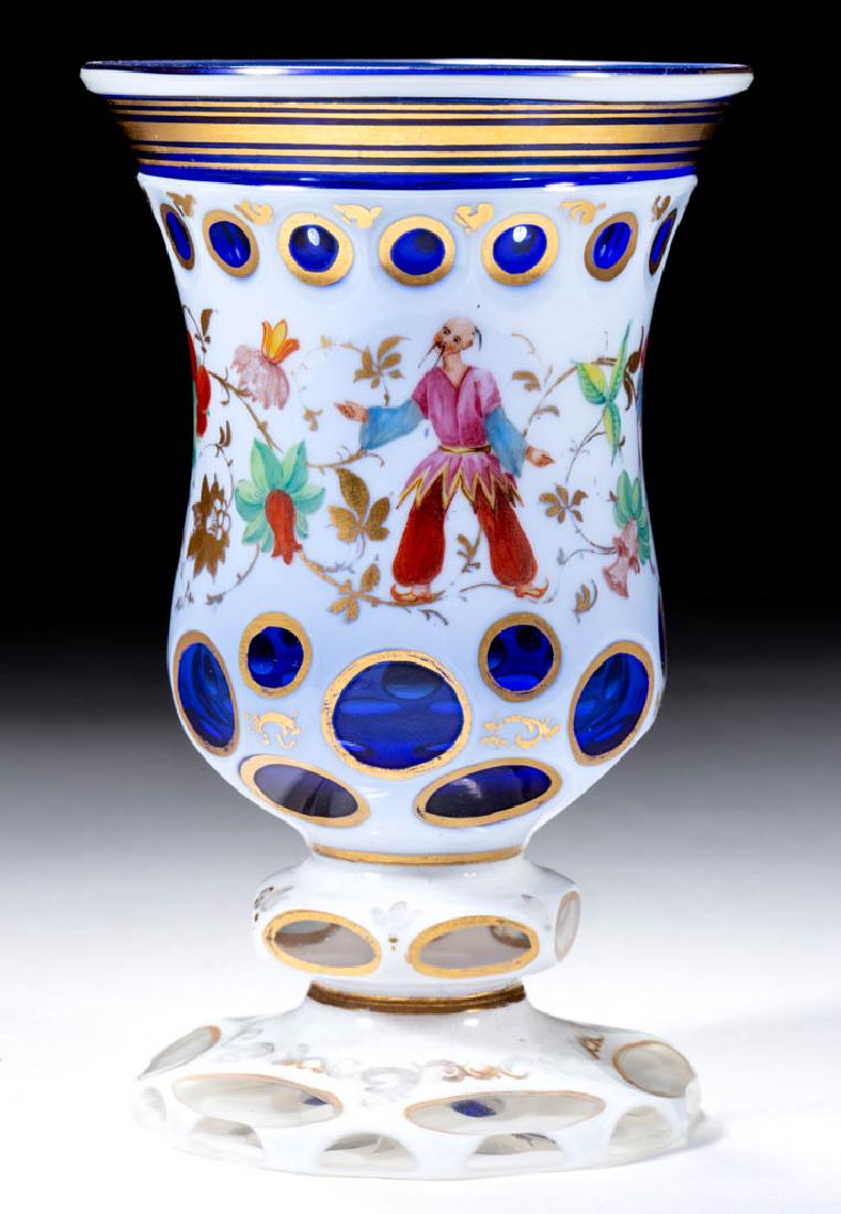 BOHEMIAN CUT-DOUBLE OVERLAY CHINOIS ERIE BEAKER: BOHEMIAN CUT-DOUBLE OVERLAY CHINOIS ERIE BEAKER, opaque white to colorless to cobalt blue, baluster-form bowl with a horizontal band near the rim and scattered punty cuts, ornate floral and Asian deco