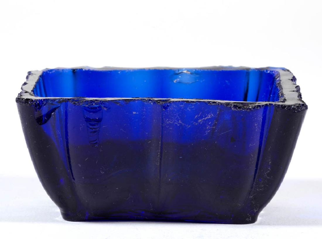 HEAVY OG-SIDE PRESSED OPEN SALT: HEAVY OG-SIDE PRESSED OPEN SALT, deep blue, rectangular form with ribs to the ends and partial sunburst under base. Probably United States. 1840-1860. 1 3/8" H, 2" x 3". Scattered chipping to the rim,
