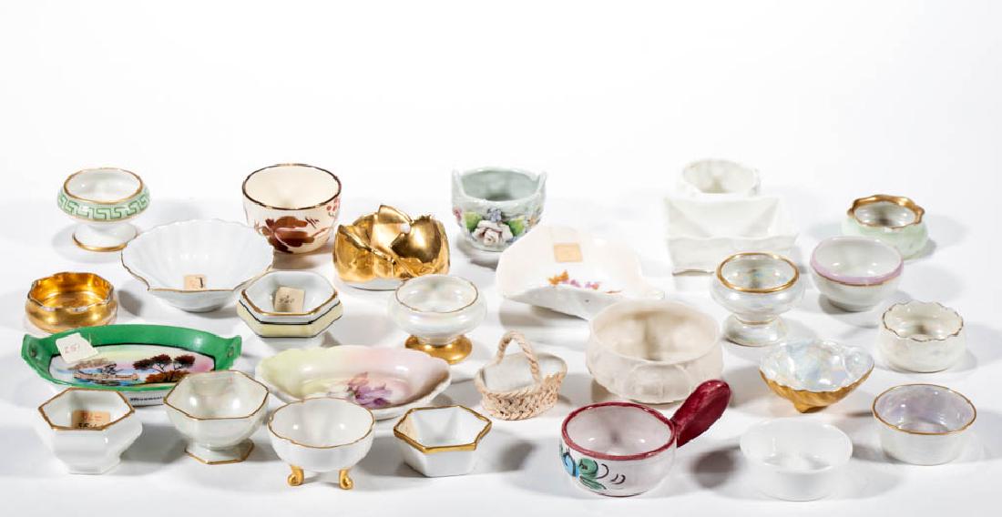 ASSORTED CERAMIC OPEN SALTS, LOT OF 26: ASSORTED CERAMIC OPEN SALTS, LOT OF 26, including a Parian example impressed "BMR" to base, RS Germany, Limoges, Czechoslovakia, Bavaria, an example with attached toothpick holder, copper luster, etc.