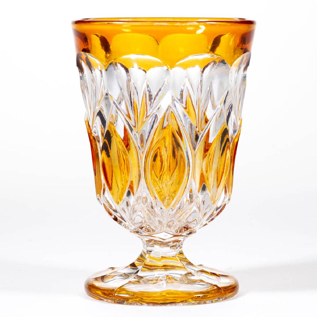 BOHEMIAN PRESSED GLASS - AMBER-STAINED SPOON / SPILL: BOHEMIAN PRESSED GLASS - AMBER-STAINED SPOON / SPILL HOLDER, colorless lead glass, factory-polished table ring, polished pontil mark. Third quarter 19th century. 5 1/8" H, 3 1/2" D rim, 2 7/8" D foot.