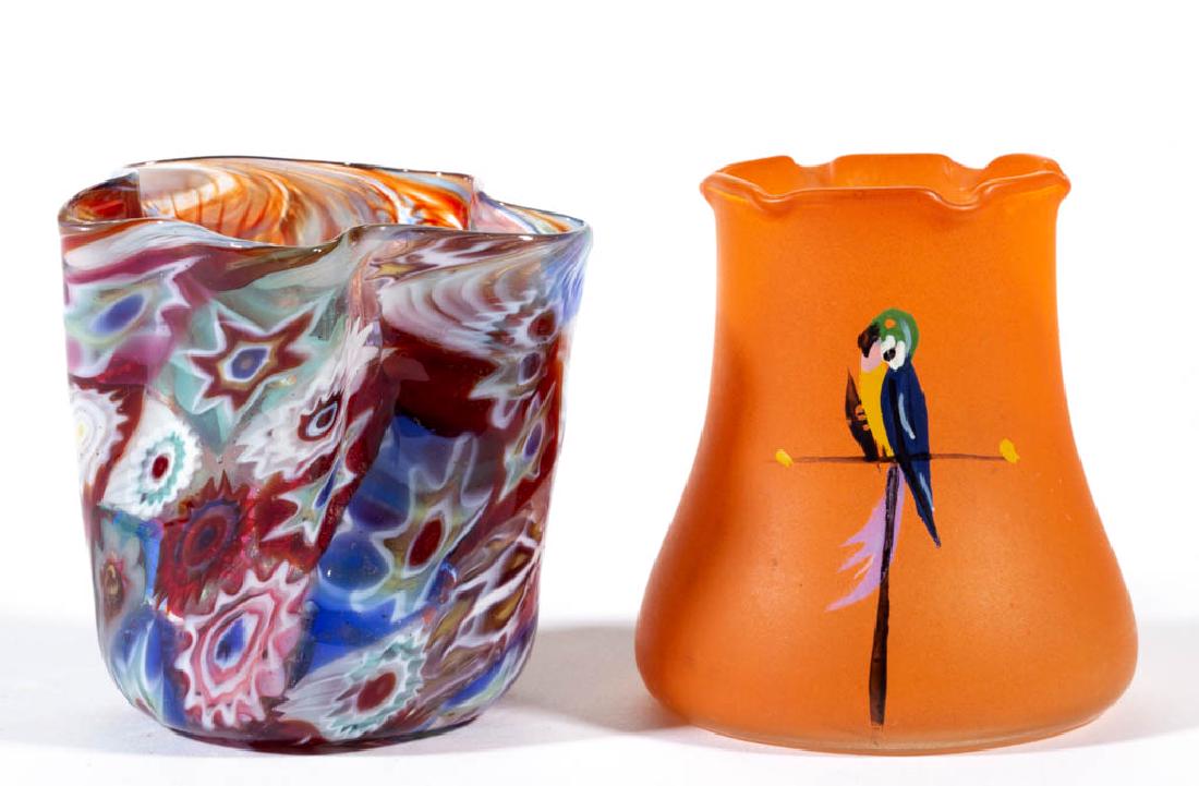 ASSORTED GLASS TOOTHPICK HOLDERS, LOT OF TWO: ASSORTED GLASS TOOTHPICK HOLDERS, LOT OF TWO, comprising an Italian millefiori and an orange-stained example with an enamel-decorated perched parrot. Makers unverified. 20th century. 2 3/8" and 2 1/2"