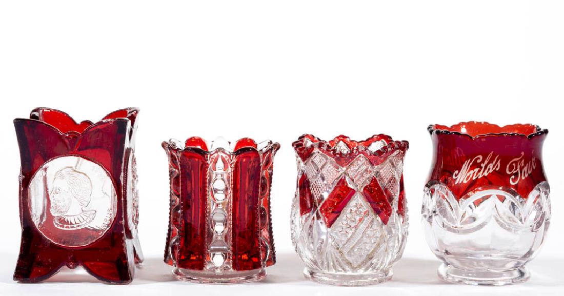 ASSORTED EAPG - RUBY-STAINED TOOTHPICK HOLDERS, LOT OF: ASSORTED EAPG - RUBY-STAINED TOOTHPICK HOLDERS, LOT OF FOUR, colorless, comprising a Dalzell Wellsburg, a Columbian Coin / World's Fair, a Eureka, and a Double Arch with souvenir decoration. Various m
