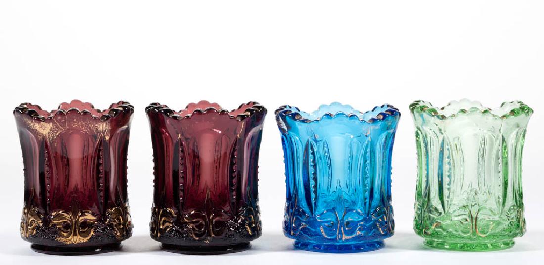 IRIS WITH MEANDER / IRIS (OMN) TOOTHPICK HOLDERS, LOT: IRIS WITH MEANDER / IRIS (OMN) TOOTHPICK HOLDERS, LOT OF FOUR, amethyst, blue, and green. Jefferson Glass Co. Circa 1903. 2 1/2" H.Undamaged with each having wear to the gilt. One amethyst example hav