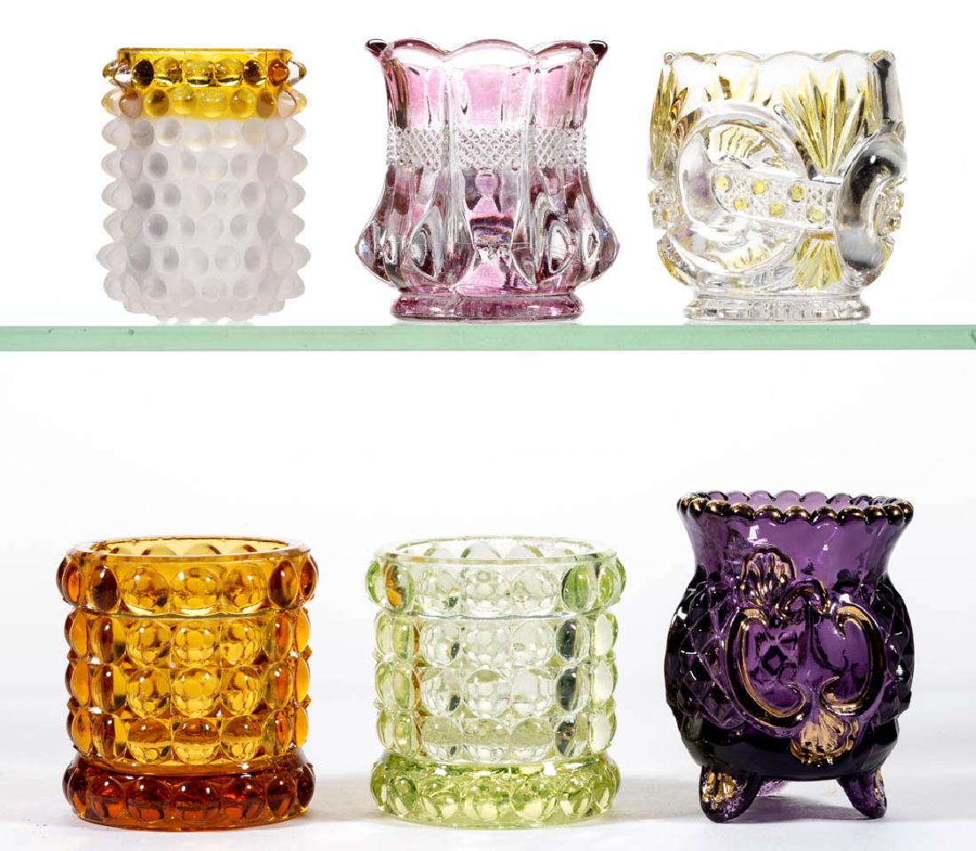 ASSORTED EAPG TOOTHPICK HOLDERS, LOT OF SIX: ASSORTED EAPG TOOTHPICK HOLDERS, LOT OF SIX, various colors, including Riverside Croesus, Hobbs Dew Drop, and amber-stained Scroll with Cane Band examples. Various makers. Fourth quarter 19th /early 2