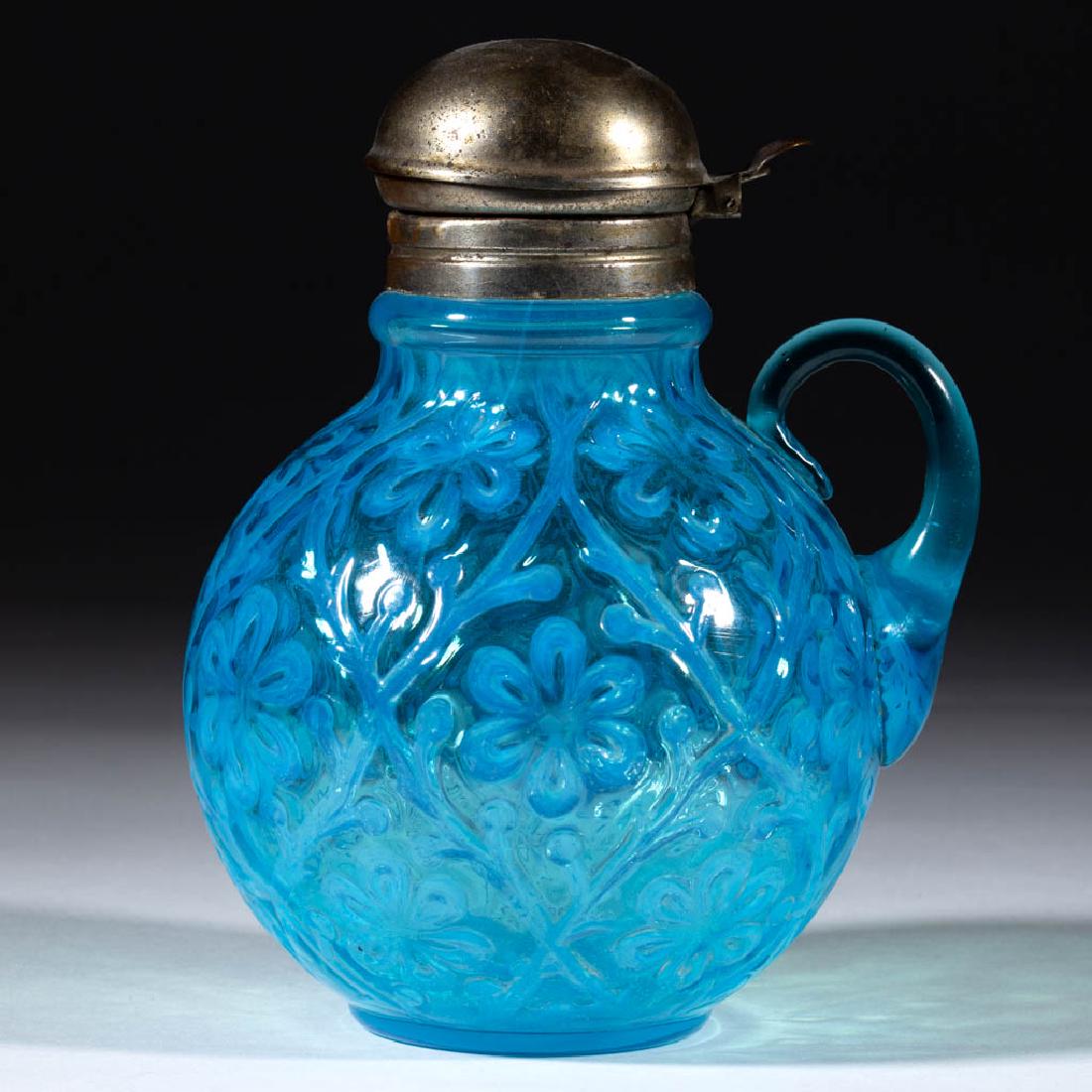 DAISY IN CRISS-CROSS SYRUP PITCHER: DAISY IN CRISS-CROSS SYRUP PITCHER, blue opalescent, applied colorless ear-like handle, period lid. Probably Beaumont Glass Co., possibly Hobbs, Brockunier & Co. Circa 1897. 6" H. Undamaged. Literatur