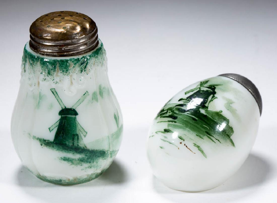 MT. WASHINGTON / PAIRPOINT DELFT SALT SHAKERS, LOT OF: MT. WASHINGTON / PAIRPOINT DELFT SALT SHAKERS, LOT OF TWO, opaque white, glossy finish, comprising a flat-side egg and a Berry example, each with green decoration depicting windmill with a sailboat in