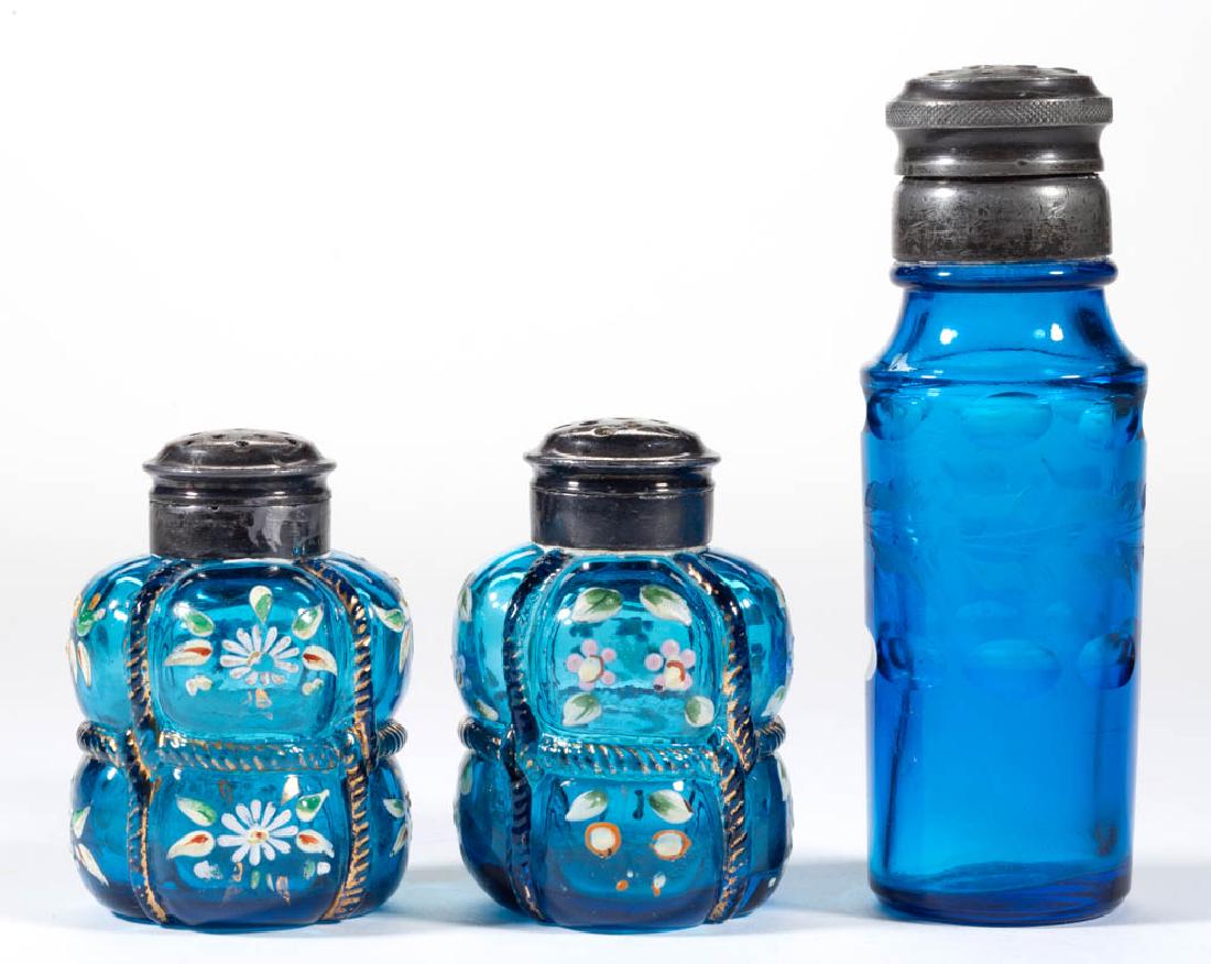 PAIRPOINT BALE ENAMEL-DECORATED NEAR PAIR OF SALT AND: PAIRPOINT BALE ENAMEL-DECORATED NEAR PAIR OF SALT AND PEPPER SHAKERS, blue with polychrome-enamel decoration, gilt decoration, each with floral decoration and period two-part lids. Together with a blu