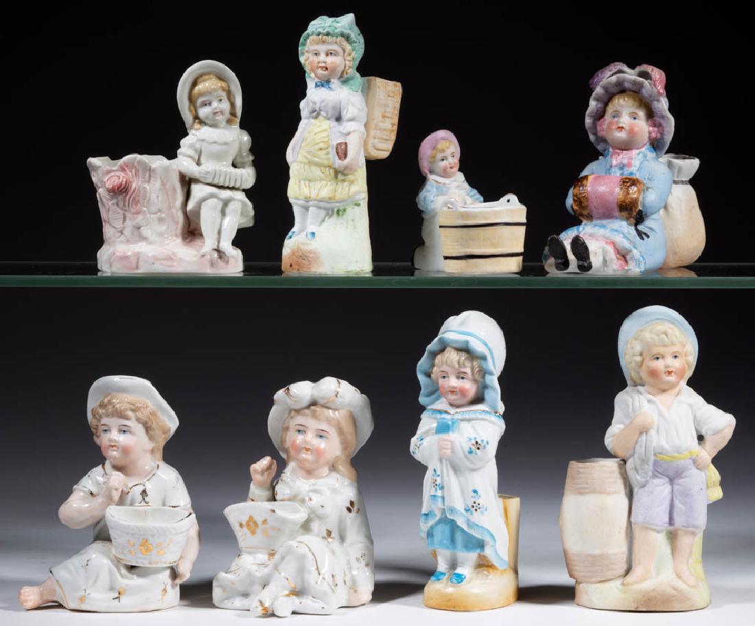 GERMAN KATE GREENAWAY-STYLE PORCELAIN FIGURES, LOT OF: GERMAN KATE GREENAWAY-STYLE PORCELAIN FIGURES, LOT OF EIGHT, comprising two recumbent figures with gilt decoration and each holding an open salt cellar basket on lap, one figure with polychrome decora