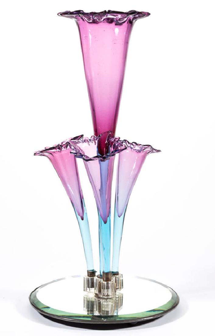 VICTORIAN BLURINA GLASS EPERGNE: VICTORIAN BLURINA GLASS EPERGNE, mirrored base with a pressed glass central mount fitted with four flower-form vases. Maker unverified. Late 19th/early 20th century. 15 1/2" HOA, 8" D base. Excellent 