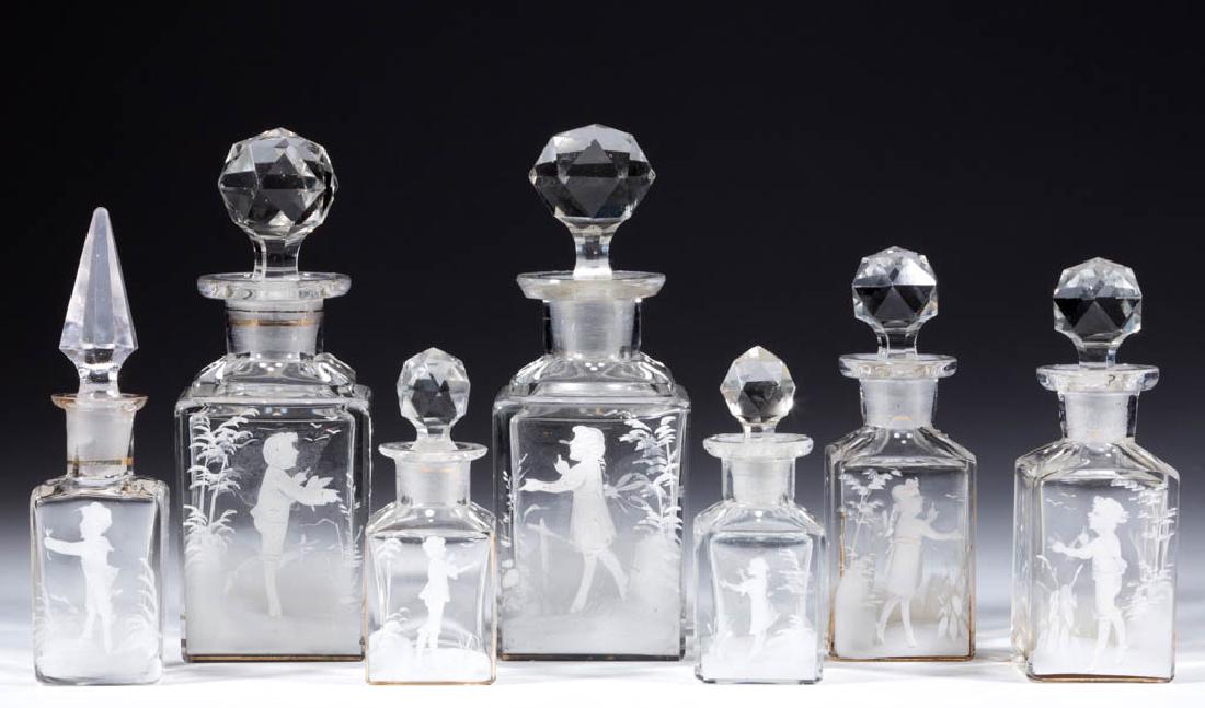 MARY GREGORY (SO-CALLED) DECORATED PERFUME BOTTLES, LOT: MARY GREGORY (SO-CALLED) DECORATED PERFUME BOTTLES, LOT OF SEVEN, colorless with polychrome-enamel decoration, each square form, six examples having cut-faceted stoppers. Maker unverified. Late 19th/e