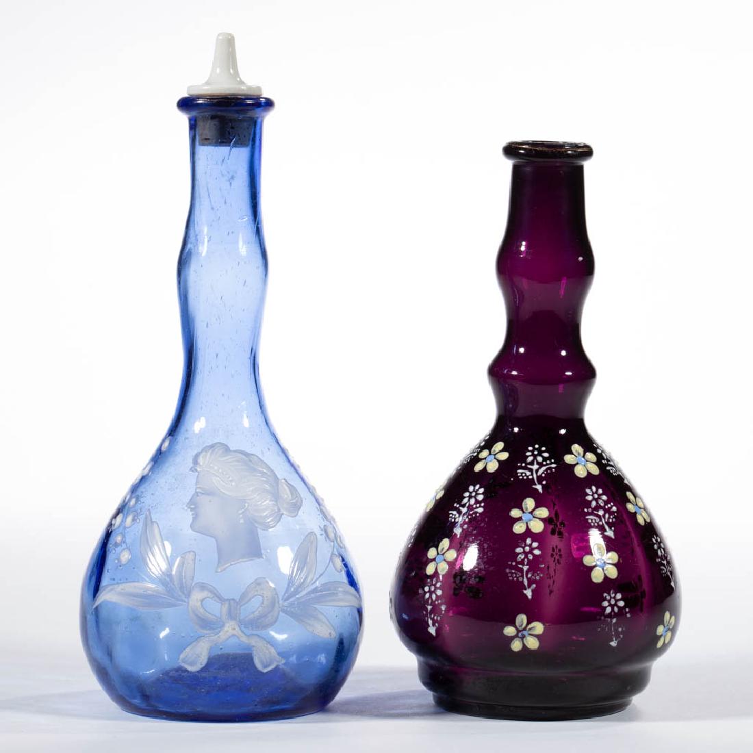 ASSORTED VICTORIAN ENAMEL-DECORATED BITTERS / BARBER'S: ASSORTED VICTORIAN ENAMEL-DECORATED BITTERS / BARBER'S BOTTLES, LOT OF TWO, comprising a blue Mary Gregory (so-called) with ceramic pour-stopper and an amethyst with floral decoration. Various makers.