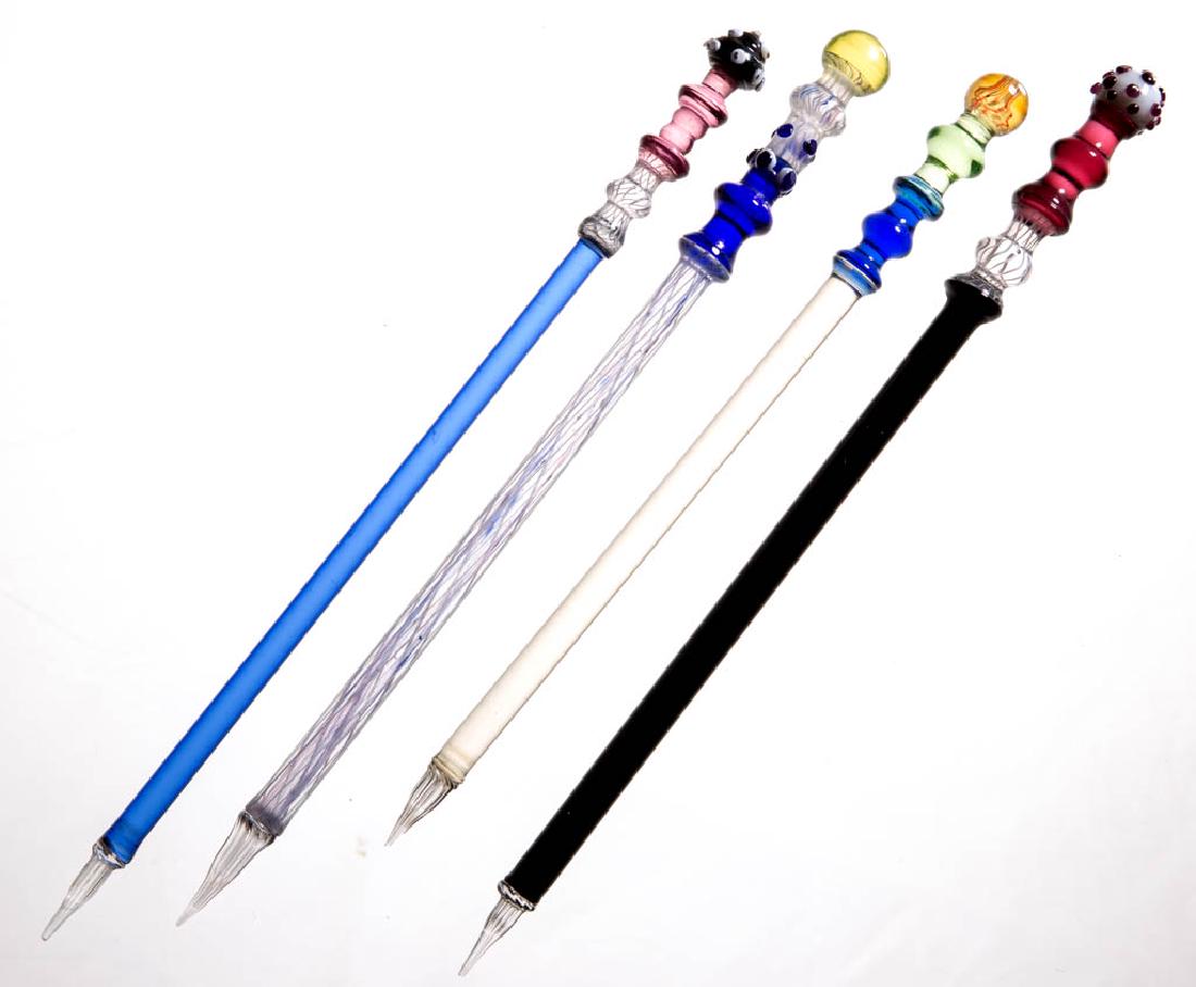 NICHOLAS LUTZ-STYLE GLASS DIPPING PENS, LOT OF FOUR: NICHOLAS LUTZ-STYLE GLASS DIPPING PENS, LOT OF FOUR, various colors, each cylindrical shaft with reeded short nib and complex finial. Nicholas Lutz, Boston & Sandwich Glass Co. and others. Third quart