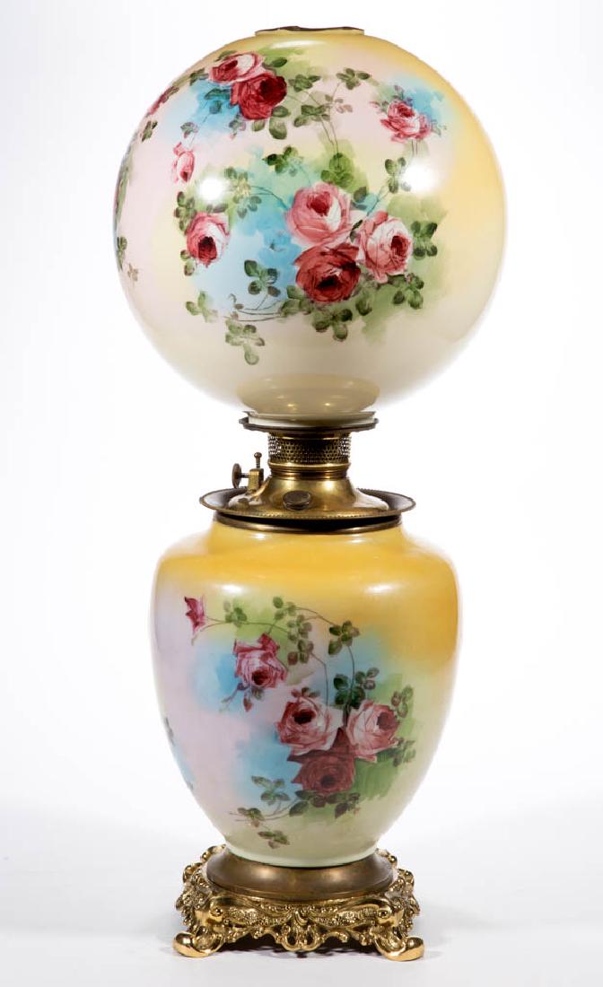 VICTORIAN ENAMEL-DECORATED PARLOR / GONE WITH THE WIND: VICTORIAN ENAMEL-DECORATED PARLOR / GONE WITH THE WIND LAMP, opaque white with yellow highlights and rose stencil decoration, matching decorated ball-form shade with brass heat ring; shouldered elonga
