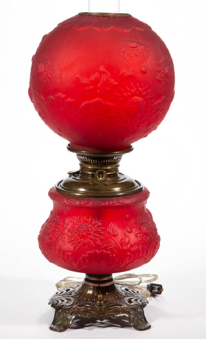 SATIN GLASS CHRYSANTHEMUM PARLOR / GONE WITH THE WIND: SATIN GLASS CHRYSANTHEMUM PARLOR / GONE WITH THE WIND LAMP, red/ruby cased, matching pattern ball-form shade with brass heat ring; globular-form font vase with concave medial, cast-iron foot with scro