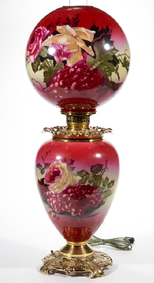 VICTORIAN ENAMEL-DECORATED PARLOR / GONE WITH THE WIND: VICTORIAN ENAMEL-DECORATED PARLOR / GONE WITH THE WIND LAMP, opaque white with dark rose ground and fruit and rose stencil decoration, matching decorated ball-form shade with beaded top brass heat rin