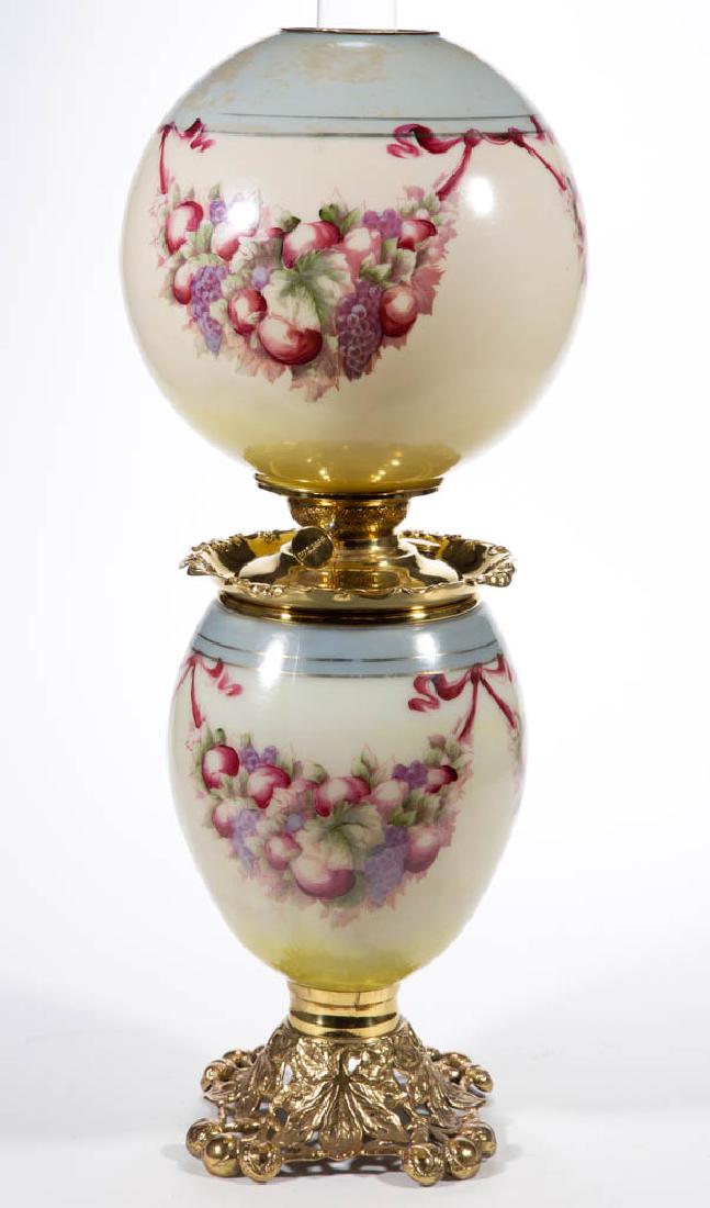 PITTSBURGH ENAMEL-DECORATED PARLOR / GONE WITH THE WIND: PITTSBURGH ENAMEL-DECORATED PARLOR / GONE WITH THE WIND LAMP, opaque white with blue shading over a cream ground, polychrome fruit and ribbon decoration, gilt-decorated bands, matching decorated ball-