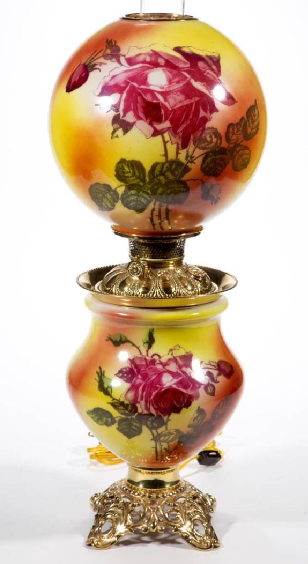 NATIONAL BRASS & IRON WORKS ENAMEL-DECORATED PARLOR /: NATIONAL BRASS & IRON WORKS ENAMEL-DECORATED PARLOR / GONE WITH THE WIND LAMP, opaque white with red oxide and yellow ground, polychrome rose stencil decoration, matching decorated ball-form shade wit