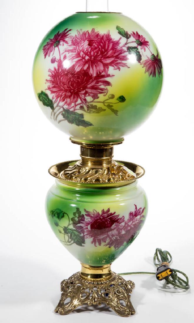 NATIONAL BRASS & IRON WORKS ENAMEL-DECORATED PARLOR /: NATIONAL BRASS & IRON WORKS ENAMEL-DECORATED PARLOR / GONE WITH THE WIND LAMP, opaque white with green and yellow ground, polychrome floral decoration, matching decorated ball-form shade with brass he