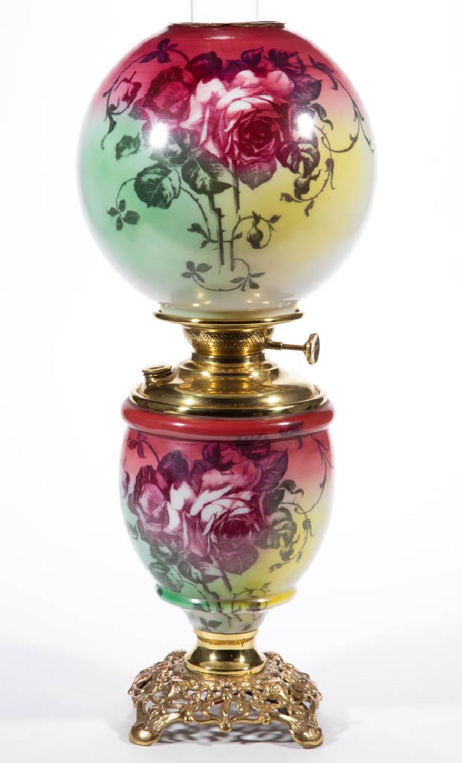 VICTORIAN ENAMEL-DECORATED PARLOR / GONE WITH THE WIND: VICTORIAN ENAMEL-DECORATED PARLOR / GONE WITH THE WIND LAMP, opaque white with dark rose, yellow and green shading, polychrome rose stencil decoration, matching decorated ball-form shade, brass heat r