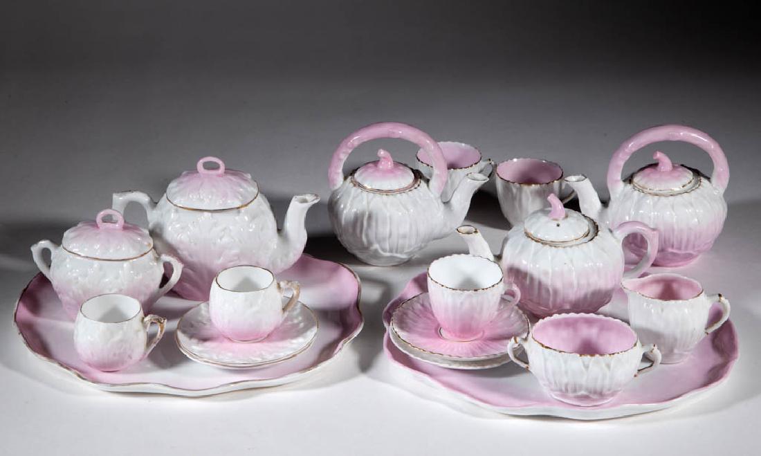 GERMAN PORCELAIN CHILDREN'S TOY TEA ARTICLES, LOT OF 16: GERMAN PORCELAIN CHILDREN'S TOY TEA ARTICLES, LOT OF 16, comprising a nine-piece and a seven-piece pink and white molded set with gilded highlights; each includes a covered teapot, sugar, two cups and