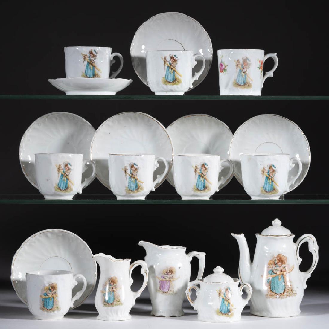 GERMAN PORCELAIN "THE BRIDESMAID" CHILDREN'S TOY: GERMAN PORCELAIN "THE BRIDESMAID" CHILDREN'S TOY 19-PIECE TEA SET, comprising a covered teapot, a 3" HOA covered sugar, two creamers, seven cups and saucers, and one mug, each having polychrome decal