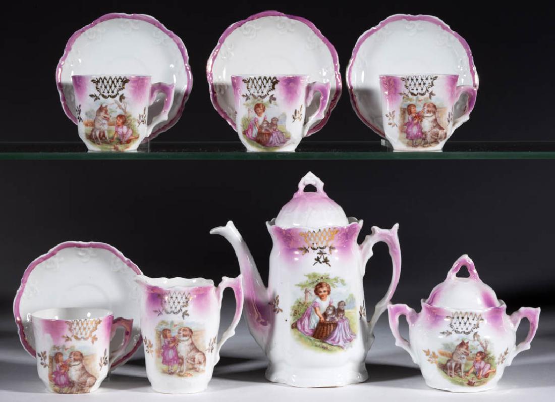 GERMAN PORCELAIN GIRLS WITH DOGS CHILDREN'S TOY: GERMAN PORCELAIN GIRLS WITH DOGS CHILDREN'S TOY 11-PIECE TEA SET, comprising a covered teapot, a covered sugar, a creamer, and four cups and saucers, each having polychrome decals of girls and dogs wi