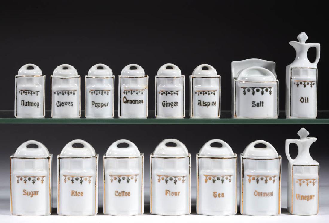 GERMAN PORCELAIN CHILDREN'S TOY 15-PIECE CANISTER SPICE: GERMAN PORCELAIN CHILDREN'S TOY 15-PIECE CANISTER SPICE SET, comprising one wall salt box, twelve canisters including "Tea", "Flour", "Cinnamon", and "Allspice", and two 3 5/8" HOA vinegar and oil cru
