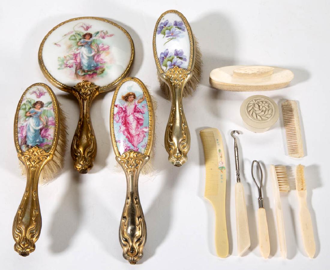 ASSORTED CERAMIC AND PLASTIC CHILDREN'S TOY DRESSER: ASSORTED CERAMIC AND PLASTIC CHILDREN'S TOY DRESSER ARTICLES, LOT OF 12, including a porcelain inset hand mirror and hair brush set with polychrome fairy and floral decal decoration and impressed "GER