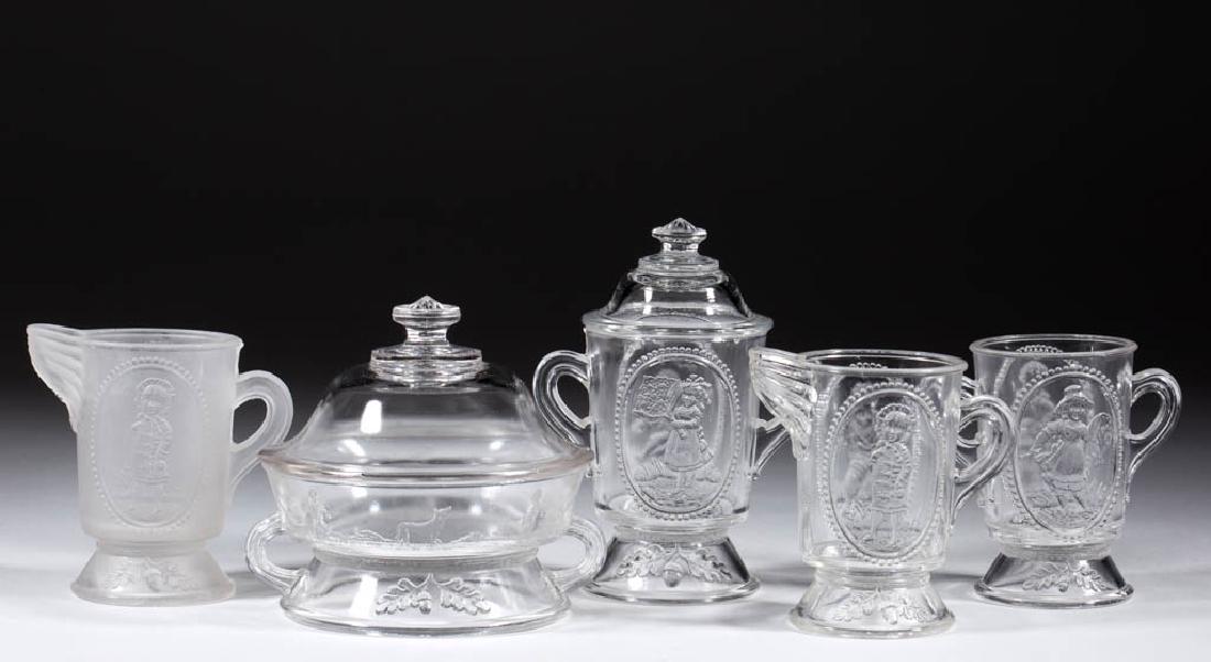 ACORN CHILDREN'S GLASS TOY FOUR-PIECE TABLE SET: ACORN CHILDREN'S GLASS TOY FOUR-PIECE TABLE SET, colorless, comprising a butter base, open sugar, creamer, and spooner. Together with a frosted colorless Acorn children's toy creamer. Five pieces tota