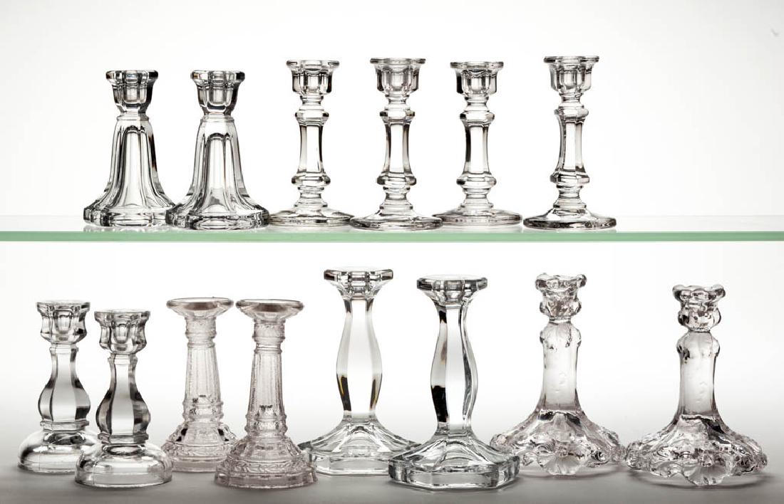 ASSORTED PRESSED GLASS CHILDREN'S TOY CANDLESTICKS, LOT: ASSORTED PRESSED GLASS CHILDREN'S TOY CANDLESTICKS, LOT OF 14, colorless, including a pair of Wild Rose, a pair of Column, and a pair of Crystal examples. Various makers. Fourth quarter 19th/first qua