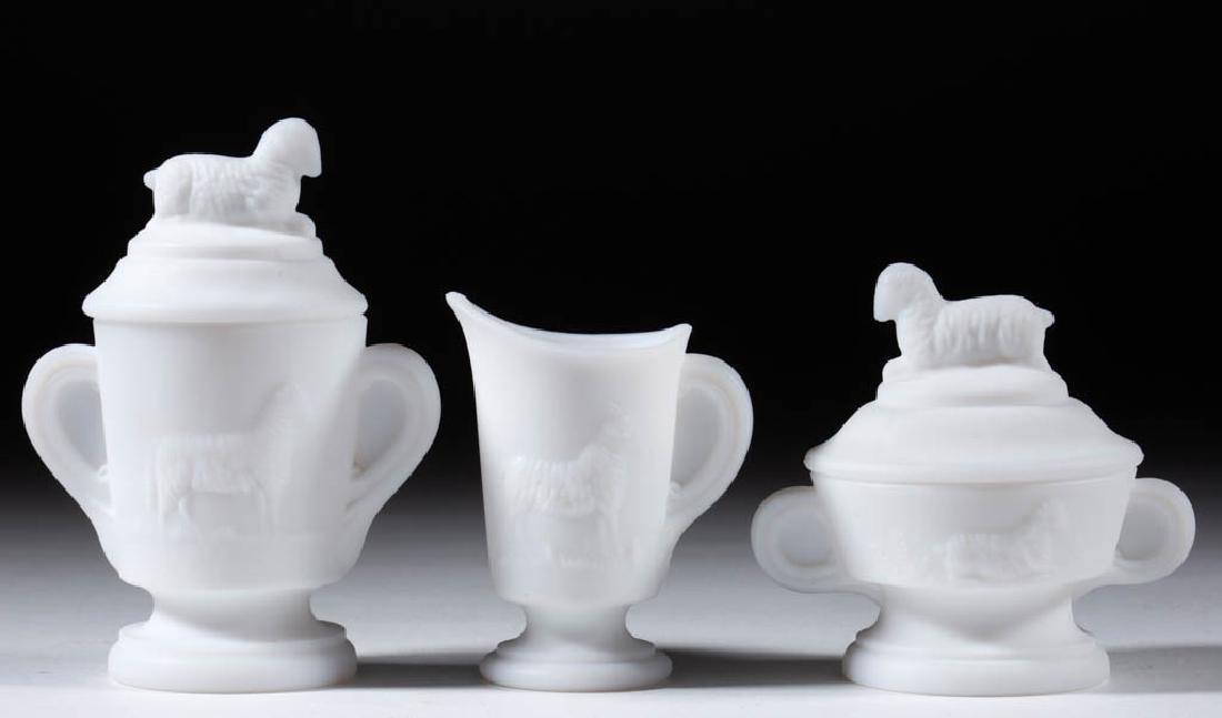 LAMB CHILDREN'S TOY THREE-PIECE TABLE SET: LAMB CHILDREN'S TOY THREE-PIECE TABLE SET, opaque white/milk glass with a plush finish, comprising a covered butter dish, covered sugar bowl, and creamer. Imperial glass Co. Circa 1910. 3" to 4 1/4" H