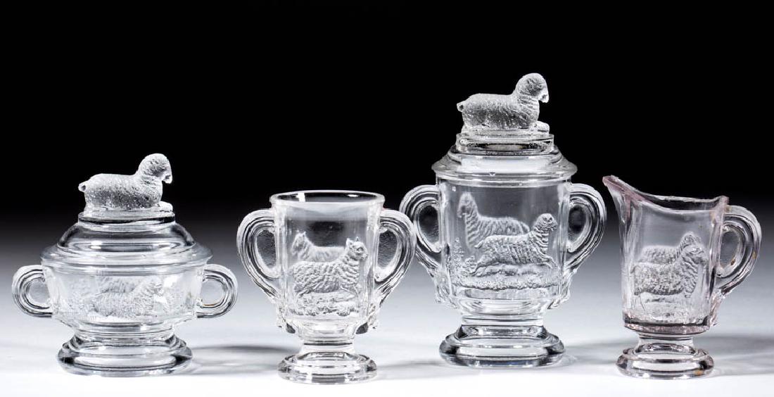 LAMB CHILDREN'S TOY FOUR-PIECE TABLE SET: LAMB CHILDREN'S TOY FOUR-PIECE TABLE SET, colorless, comprising a covered butter dish, covered sugar bowl, creamer, and spooner. Imperial glass Co. Circa 1910. 3" to 4 1/4" HOA.Spooner with post-produ