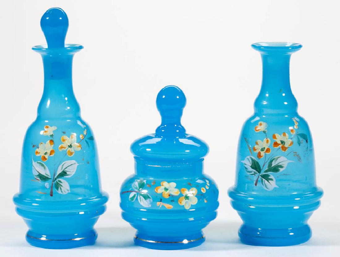 ASSORTED OPALINE GLASS CHILDREN'S TOY ARTICLES, LOT OF: ASSORTED OPALINE GLASS CHILDREN'S TOY ARTICLES, LOT OF THREE, blue opaline with polychrome enamel-decoration, comprising two decanters with one having the original stopper, and a covered jar. Maker un