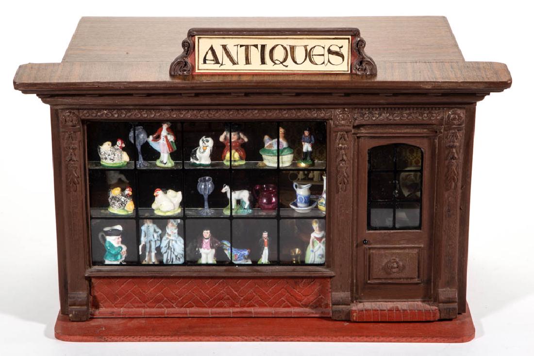 ANTIQUE STORE DIORAMA: ANTIQUE STORE DIORAMA, wood construction with hinged front wall and an interior light. Together with various dollhouse/miniature articles including a corner cupboard by Mell Prescott, a shelf clock an