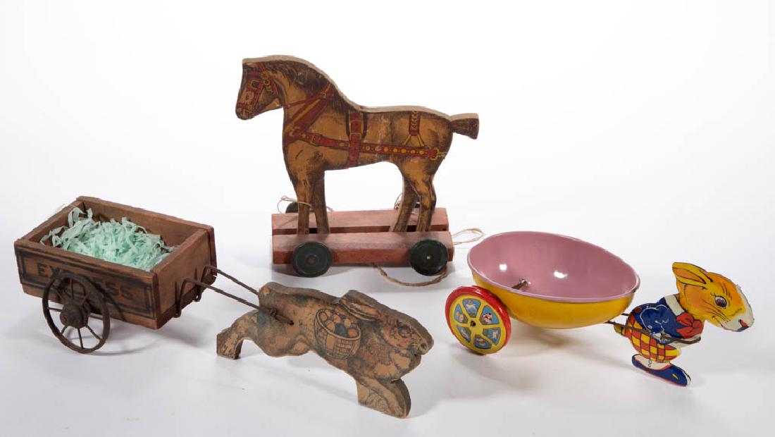 VINTAGE WOOD / TIN TOYS, LOT OF THREE: VINTAGE WOOD / TIN TOYS, LOT OF THREE, comprising a wooden horse pull toy, a wooden rabbit pulling an "EXPRESS" cart, and a lithograph tin toy of a rabbit pulling an egg-shaped cart. Tin toy with "J. 