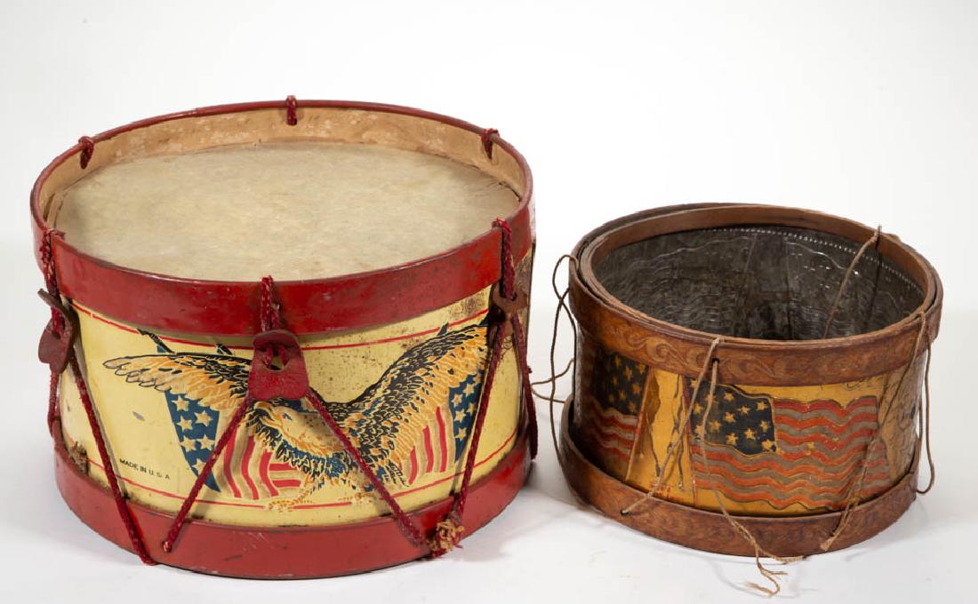 AMERICAN PATRIOTIC TOY DRUMS, LOT OF TWO: AMERICAN PATRIOTIC TOY DRUMS, LOT OF TWO, comprising a lithographed tin body featuring eagles on a stars and stripes background, tin bands, drum-head top is "Skin Bead" and canvas bottom, and an embos