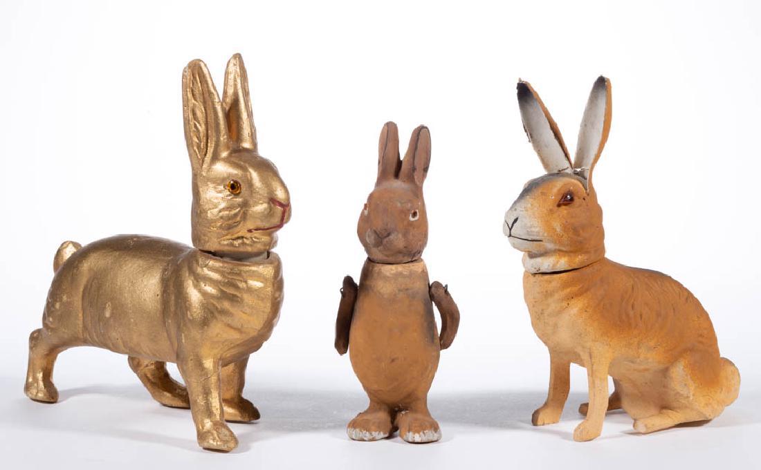 GERMAN COMPOSITION / PAPIER-MACHE RABBIT CANDY: GERMAN COMPOSITION / PAPIER-MACHE RABBIT CANDY CONTAINERS, LOT OF THREE, each having polychrome finish, removable head with applied eyes, one standing example with movable arms. Two examples with prin