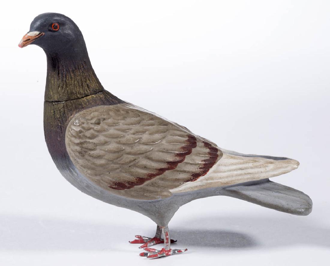 GERMAN COMPOSITION / PAPIER-MACHE PIGEON CANDY: GERMAN COMPOSITION / PAPIER-MACHE PIGEON CANDY CONTAINER, having polychrome-painted finish, removable head, and metal legs. Unmarked. First quarter 20th century. 5" HOA. Some scattered flakes notably 