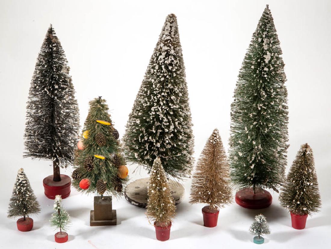 ASSORTED MINIATURE CHRISTMAS TREES, LOT OF TEN: ASSORTED MINIATURE CHRISTMAS TREES, LOT OF TEN, nine having faux snow accents and resting on painted bases, and one example with faux fruit, pine cones, and gold-toned accents. Unmarked. 20th century.