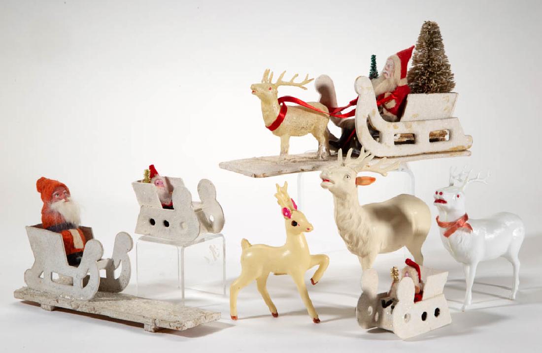 GERMAN AND JAPANESE SANTA CLAUS AND REINDEER FIGURES,: GERMAN AND JAPANESE SANTA CLAUS AND REINDEER FIGURES, LOT OF SEVEN, comprising four Santa examples in pasteboard sleighs and three celluloid/plastic reindeer examples. Small Santa example mounted on b