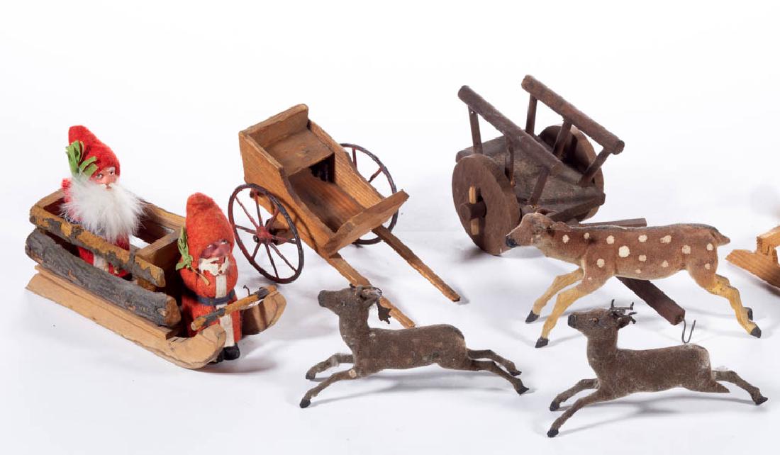 GERMAN AND OTHER CHRISTMAS / HOLIDAY FIGURES, LOT OF: GERMAN AND OTHER CHRISTMAS / HOLIDAY FIGURES, LOT OF EIGHT, comprising two sitting Santa Claus examples, three deer, a wooden sleigh, and two wooden carts. Santas and sleigh with "Germany" marks or la