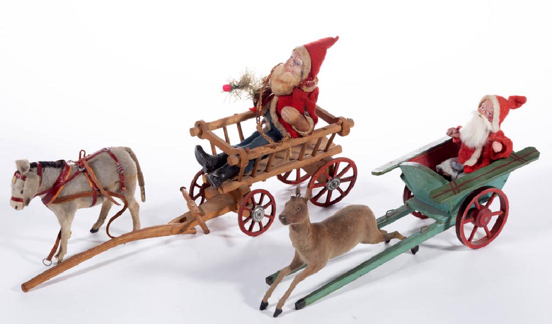 GERMAN AND OTHER CHRISTMAS / HOLIDAY FIGURES, LOT OF: GERMAN AND OTHER CHRISTMAS / HOLIDAY FIGURES, LOT OF SIX, comprising two Santa Claus examples, two carts, a deer, and a donkey. Green and red cart with printed "Germany" mark to base. First half 20th