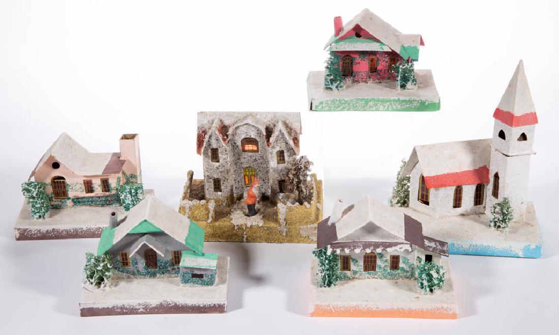JAPANESE CARDBOARD CHRISTMAS HOUSES, LOT OF SIX: JAPANESE CARDBOARD CHRISTMAS HOUSES, LOT OF SIX, each having painted and glitter finish, cellophane windows, and faux trees, one example with a composition Santa Claus figure. Each with printed "JAPAN