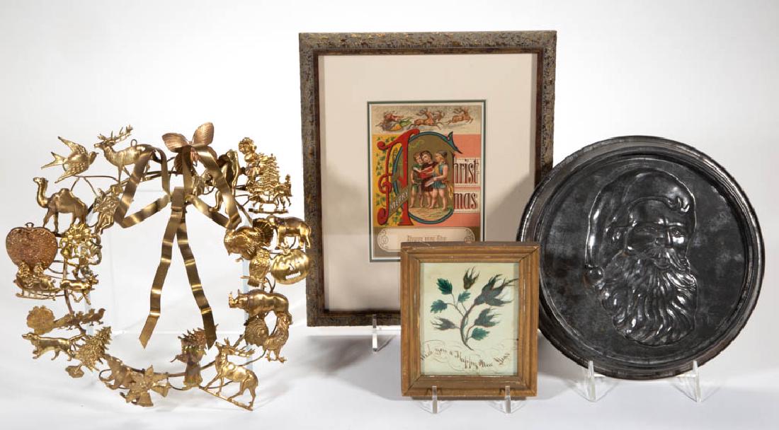 ASSORTED HOLIDAY ARTICLES, LOT OF FOUR: ASSORTED HOLIDAY ARTICLES, LOT OF FOUR, comprising a framed lithograph Christmas card, a framed painted New Year card, a Santa Claus mold metal pan, and a brass-toned metal holiday wreath. Late 19th/2