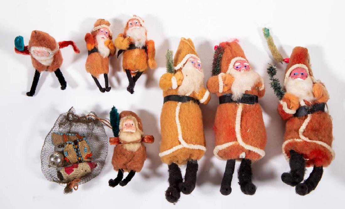 JAPANESE COTTON SANTA CLAUS ORNAMENTS, LOT OF SEVEN: JAPANESE COTTON SANTA CLAUS ORNAMENTS, LOT OF SEVEN, each having composition face with polychrome-painted finish, including one example with bag. Six with printed "MADE IN JAPAN" or "MADE IN / OCCUPIE
