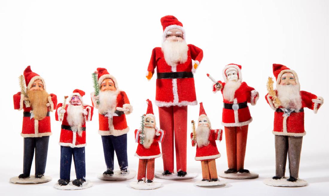 JAPANESE SANTA CLAUS FIGURES, LOT OF EIGHT: JAPANESE SANTA CLAUS FIGURES, LOT OF EIGHT, each wearing a red coat and hat, most holding a faux branch. Seven pieces with "JAPAN" label or mark. First half/mid 20th century. 4 1/8" to 8 1/2" HOA. All