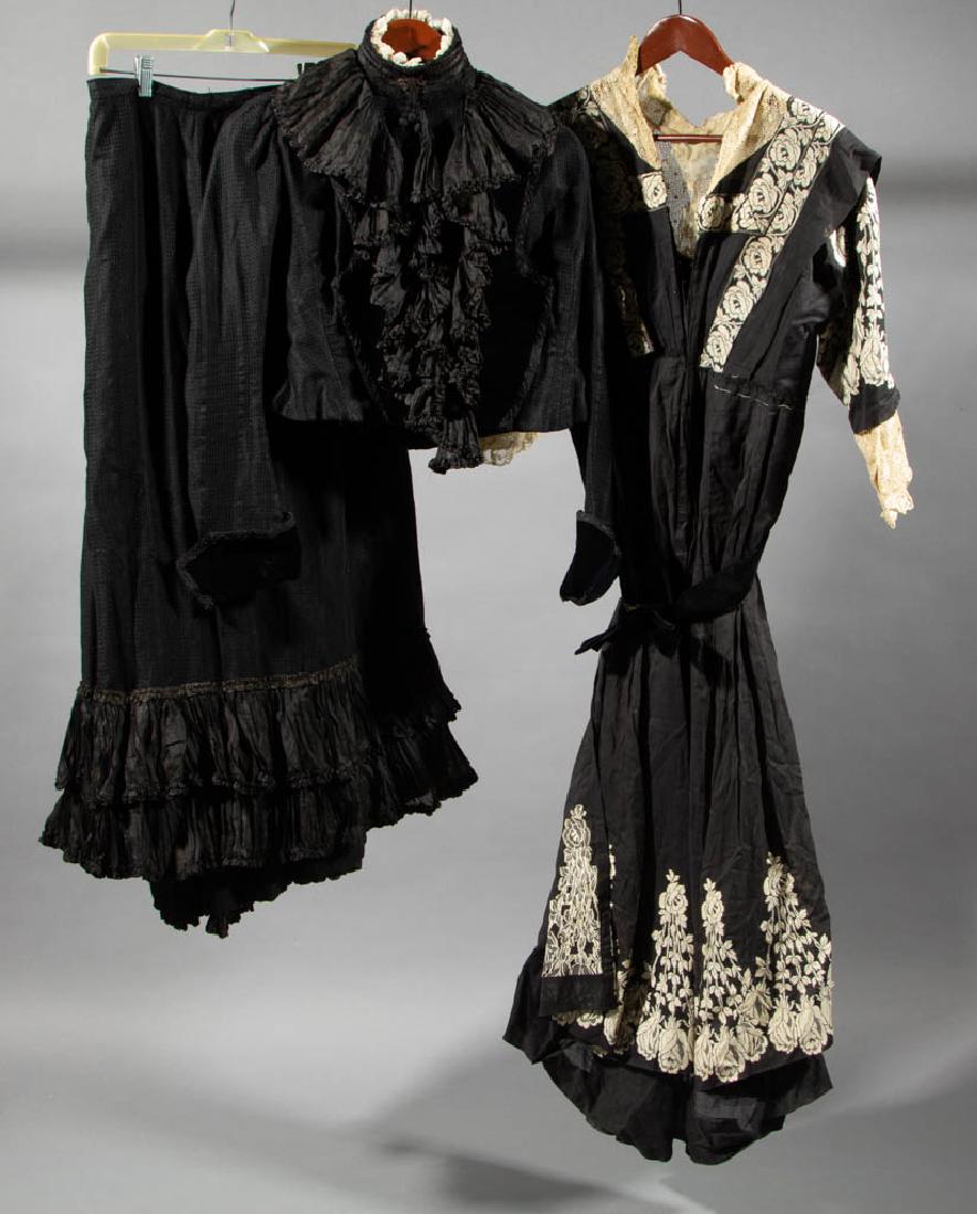 VICTORIAN / EDWARDIAN BLACK DRESSES, LOT OF TWO: VICTORIAN / EDWARDIAN BLACK DRESSES, LOT OF TWO, each having high-collared neckline and velvet accents, comprising a two-pieced ensemble of a bodice and skirt with ruffled accents and an embroidered e